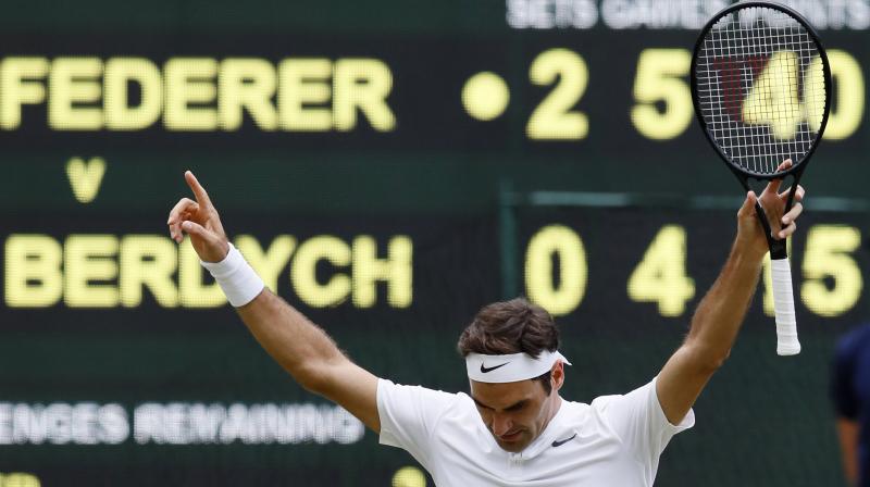Switzerlands Roger Federer celebrates after beating Czech Republics Tomas Berdych at the end of their Mens Singles semifinal match at the Wimbledon Tennis Championships. (Photo: AP)