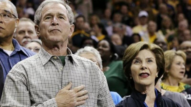 Former President George W. Bush with his wife Laura. (Photo: AP)