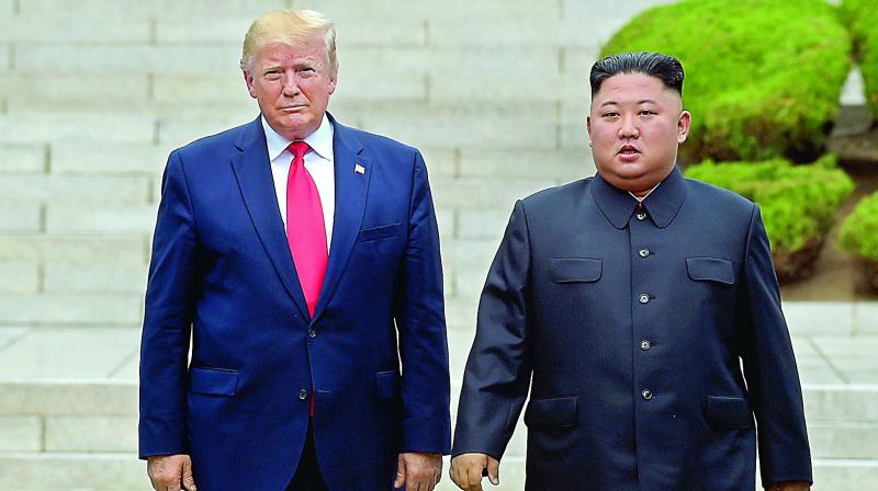 US President Donald Trump and North Korean leader Kim Jong Un at the North Korean side of the border at the village of Panmunjom in Demilitarised Zone on Sunday. (Photo: AP)