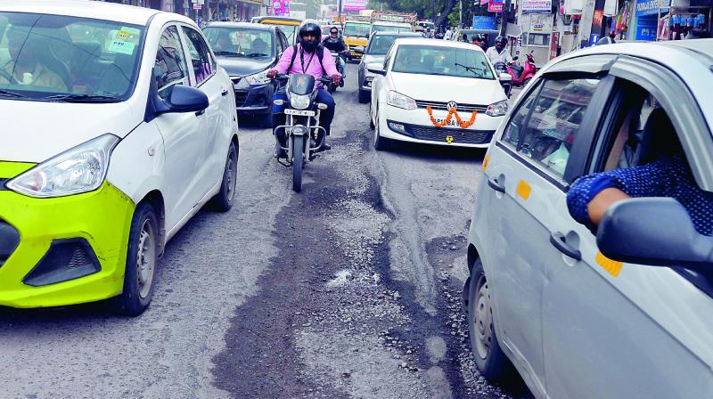 Motorists face difficulties due to damaged roads on the Karimnagar Highway at Karkhana. (Photo: P. Surendra)