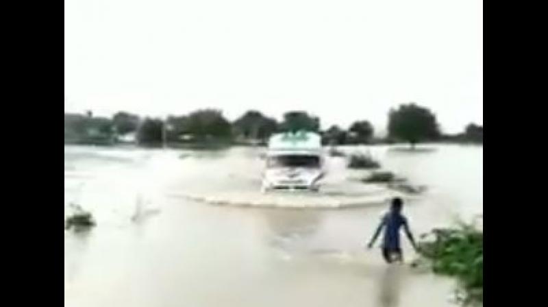 Watch: 12-year-old boy risks life to guide ambulance over flooded bridge in K\taka