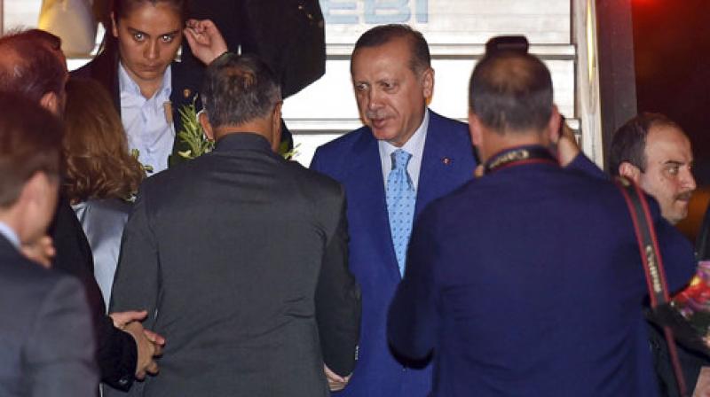 Turkeys President Recep Tayyip Erdogan greets waiting officials upon arrival in New Delhi, India, Sunday, April 30, 2017. Erdogan is on a two-day visit to India. (Photo: AP)
