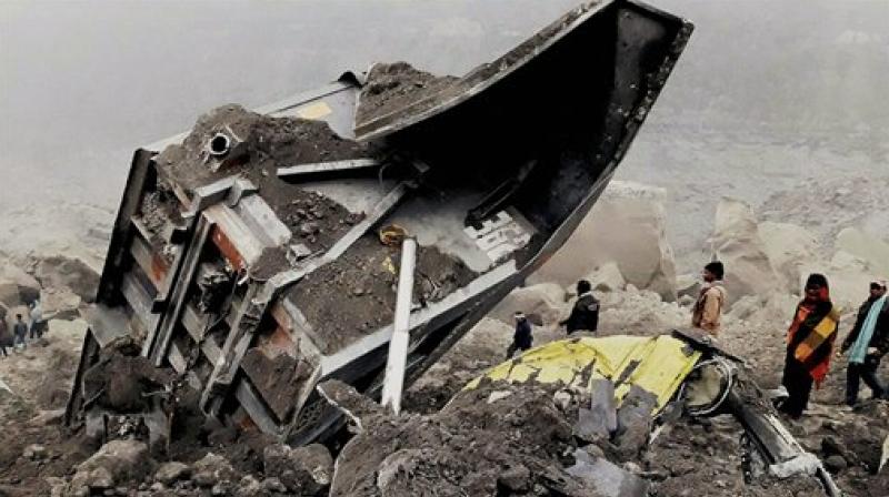 People gather near the coal mine in Godda, Jharkhand, where several workers are trapped, after it collapsed on Thursday evening. (Photo: PTI)