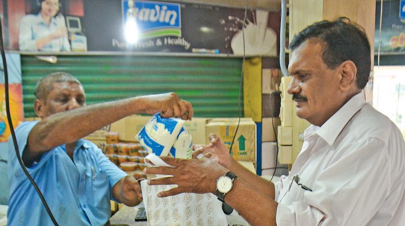 A man buys Aavin milk in Chennai on Saturday, following the announcement on chemical content in milk supplied  by private dairies. (Photo: DC)
