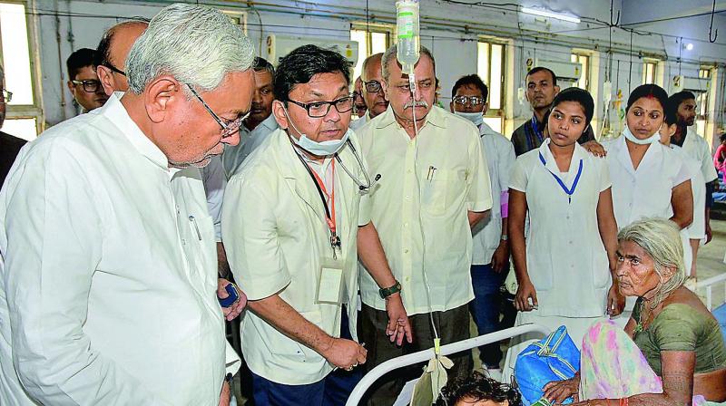 Bihar Chief Minister Nitish Kumar along with deputy CM Sushil Kumar Modi visits children suffering from Acute Encephalitis Syndrome at a hospital in Muzaffarpur district on Tuesday. (Photo: PTI)