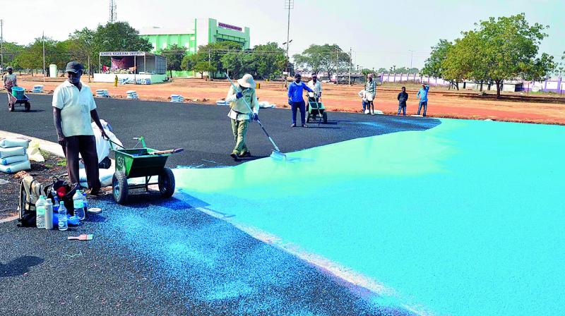 Workers lay the synthetic track in ANU premises on Tuesday. (Photo: DC)