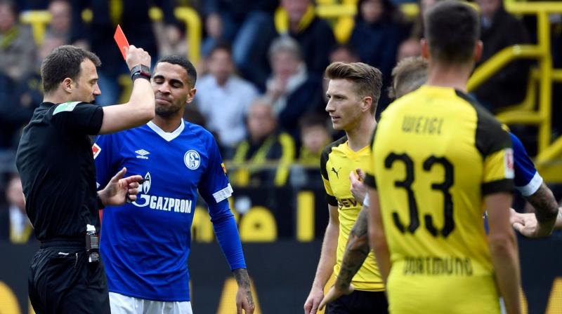 Borussia Dortmund\s title hunt dealt a blow as Reus and Wolf receive ban