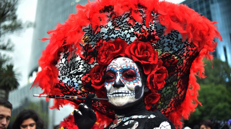 People fancy dressed as \Catrina\ take part in the \Catrinas Parade\ along Reforma Avenue, in Mexico City on October 21, 2018. (Photo: AFP)