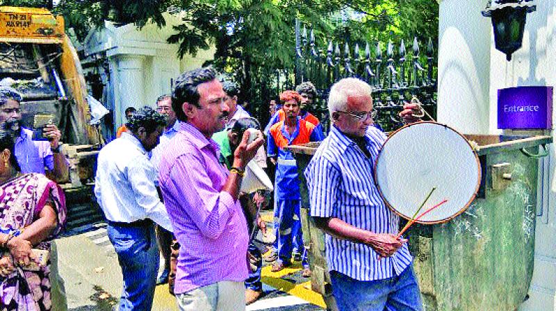 Chennai Corporation officials beat thandora in front of the star hotel on TTK Road on Tuesday. (Photo: DC)