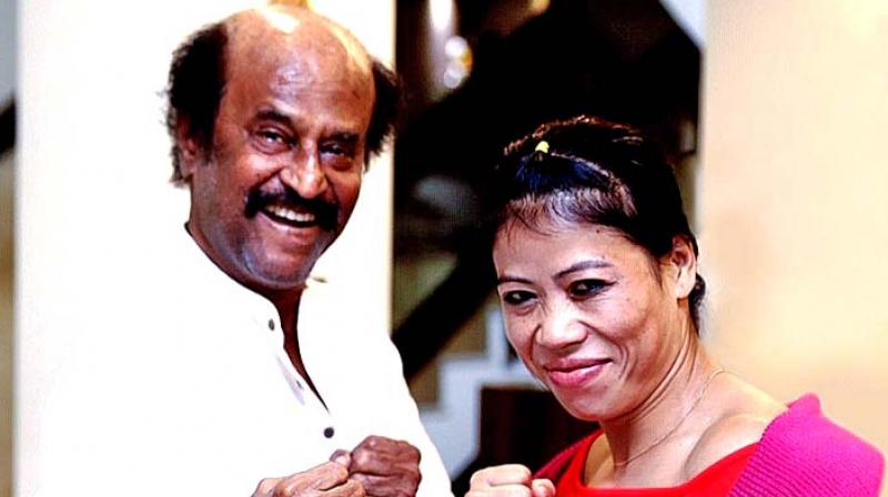 Superstar Rajinikanth strikes a boxing pose with Mary Kom during their meeting at his house on Friday .