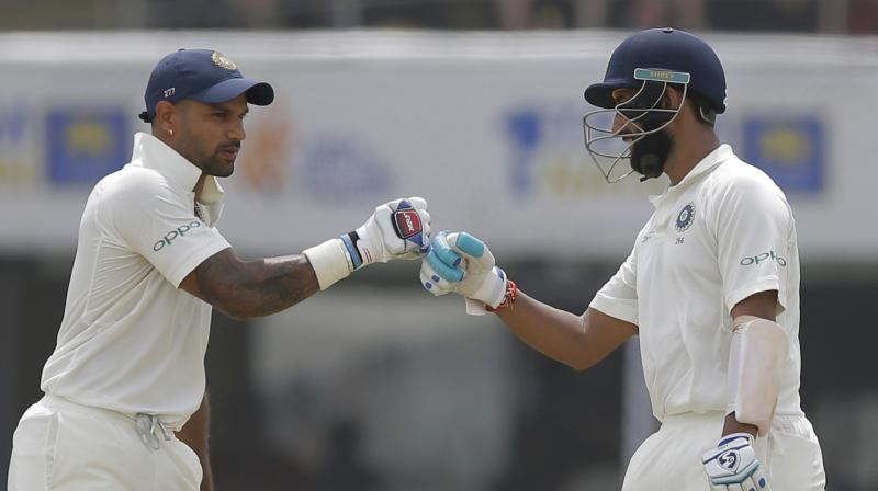 Shikhar Dhawan and Cheteshwar Pujara put up a 253-run partnership for the second wicket  (Photo: AP)