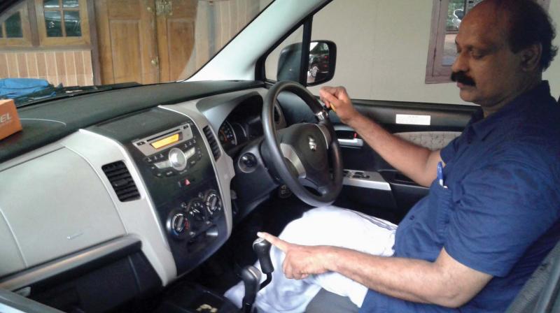 Thorappa  Mustafa in his car equipped with finger control technology. (Photo: DC)