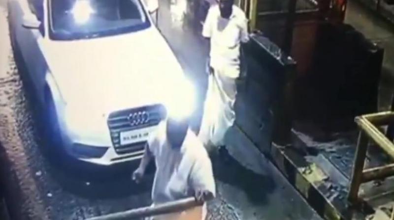 A CCTV video footage at the plaza purportedly shows the MLA getting out of the car and damaging the barrier, along with his aides. (Photo: Screengrab | ANI video)