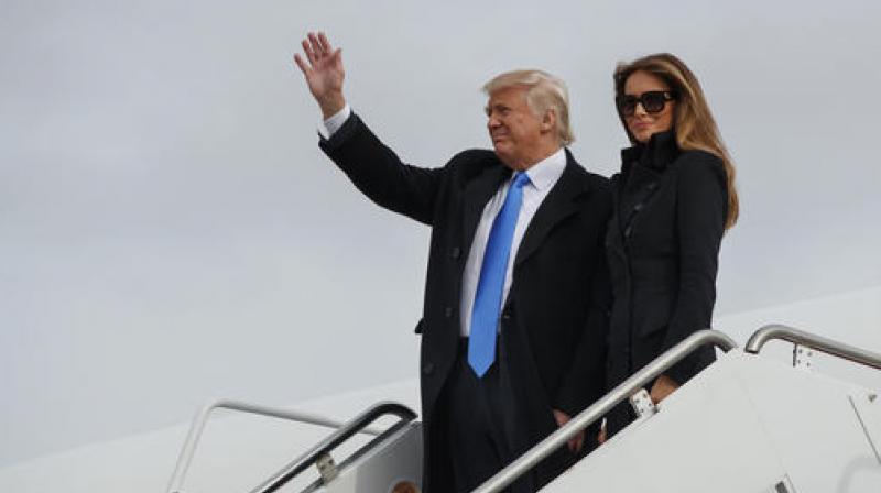 President-elect Donald Trump, accompanied by his wife Melania Trump, waves as they arrive at Andrews Air Force Base. (Photo: AP)