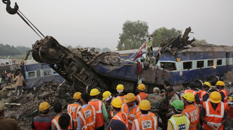 Rescuers search in the debris after 14 coaches of a passenger train derailed near Pukhrayan village Kanpur Dehat district, Uttar Pradesh. (Photo: AP)