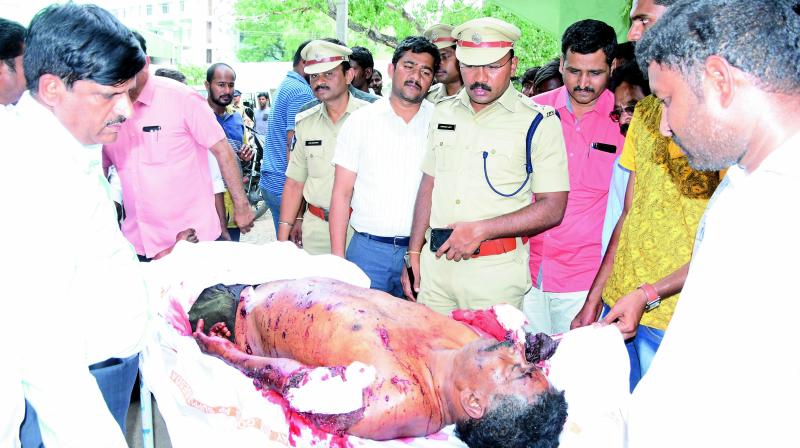 Police inspects the body of one of the blast victims in Kurnool on Tuesday.