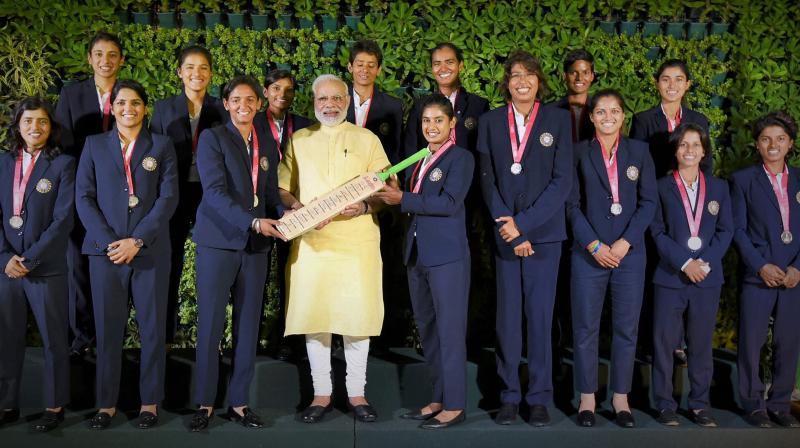 Prime Minister Narendra Modi in a group photograph with the Indian womens cricket team, in New Delhi on Thursday. (Photo: PTI)