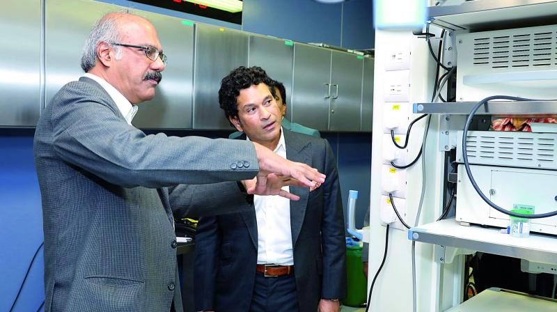Asian Institute of Gastroenterology chairman Dr Nageshwar Reddy gives a personal tour to Sachin Tendulkar of the hospital campus.