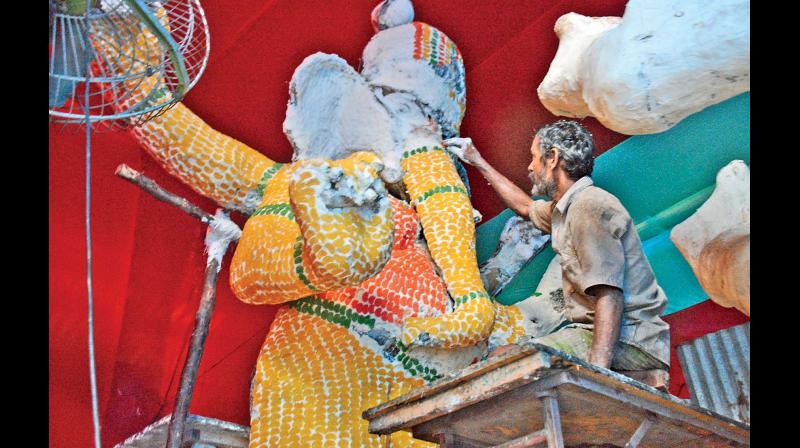 With Vinayaka Chathurthi around the corner, a worker at T. Nagar gives final touches to a 15-foot tall idol of Ganesha made of 200 kg candy	(Photo: DC)