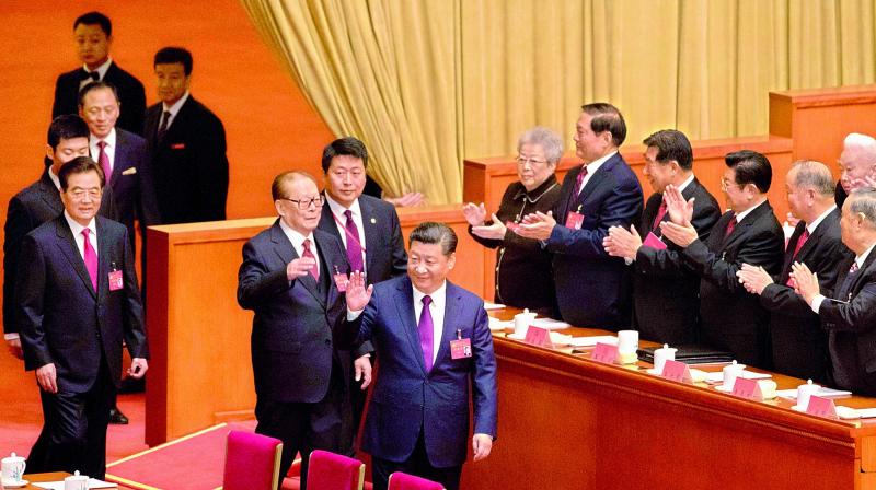 Chinese President Xi Jinping, front right, waves as he walks ahead of former Chinese Presidents Jiang Zemin and Hu Jintao as they arrive for the opening ceremony of the 19th Party Congress. (Photo: AP)