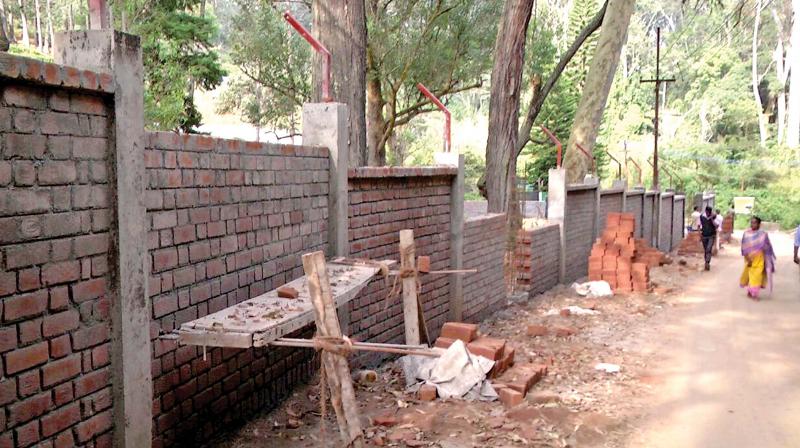 Construction of compound wall is underway along the boundary of Sims Park in Coonoor.	(Photo: DC)