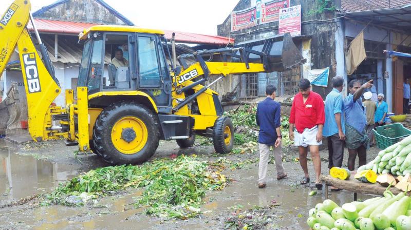 Corporation workers on a cleaning mission in the Palayam market, Kozhikode.