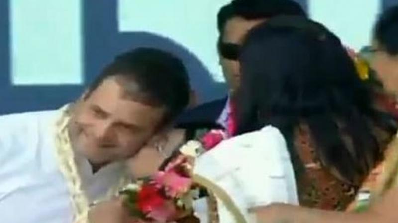 Rahul Gandhi blushed after the woman drags down his head and kisses him. (Photo: ANI | Twitter)