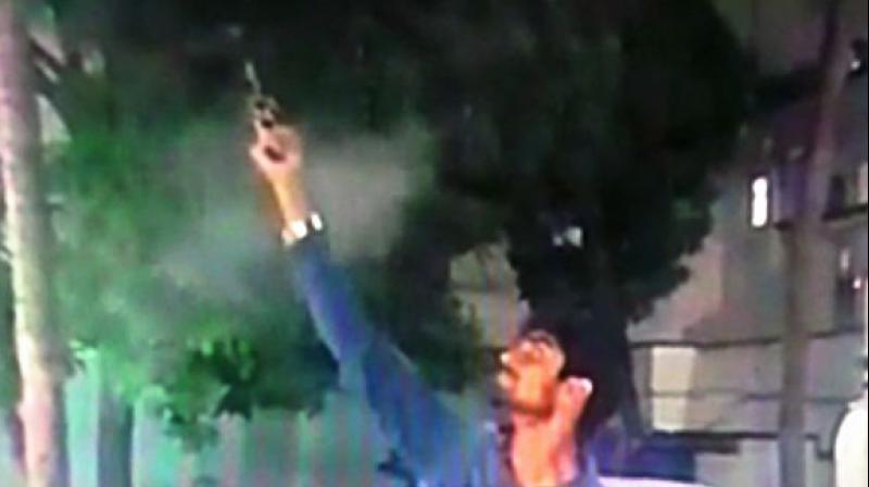 This image shows the man Mirza Ibrahim Ali Baig firing his gun in the air. (Photo: DC)