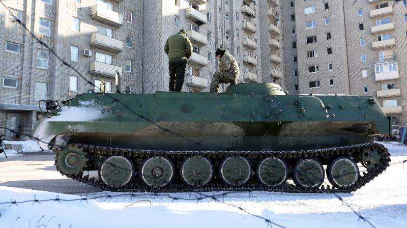 Ukrainian medical servicemen stand on an Armoured Personnel Carriers (APC) after they carried wounded servicemen to hospital in Ukraine-controlled town of Avdiivka, in Donetsk region on January 30, 2017. (Photo: AFP)