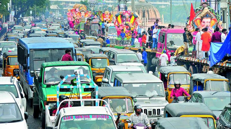 Motorists stuck in heavy traffic jam near Tank Bund as idol immersions continue at Hussain Sagar on Wednesday morning.  	(Photo:DC)