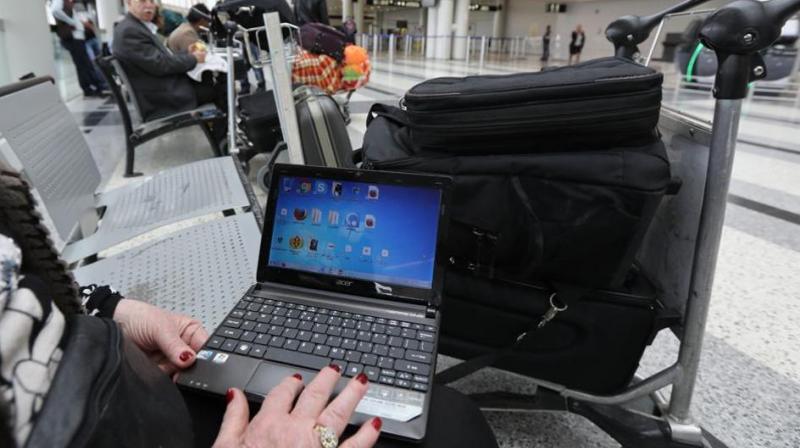 A woman checks her laptop at the Beirut international airport. The US and the UKâ€‰have banned laptops and other devices on flights from some countries. (Photo: AFP)