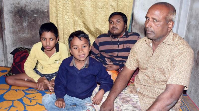 In this photograph, Bangladeshi father and fruit vendor Tofazzal Hossain who has sparked a debate over assisted suicide, is seen with his two sons and grandson in Meherpur. (Photo: AFP)