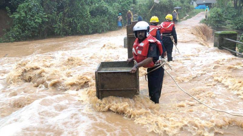 Quick Response Team (QRT) carrying out rescue operations in flood hit areas of Kodagu district.(Image Dc)