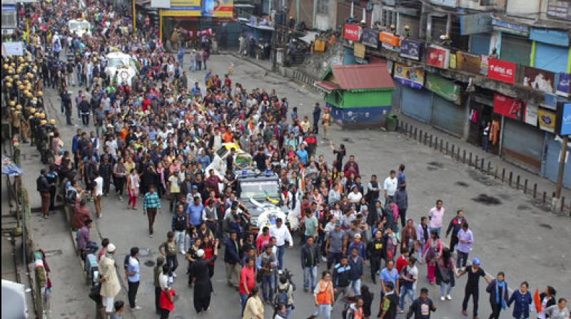 Activists of Gorkha Janmukti Morcha (GJM) take out a funeral procession with the bodies of their three activists who were killed Saturday. (Photo: PTI)