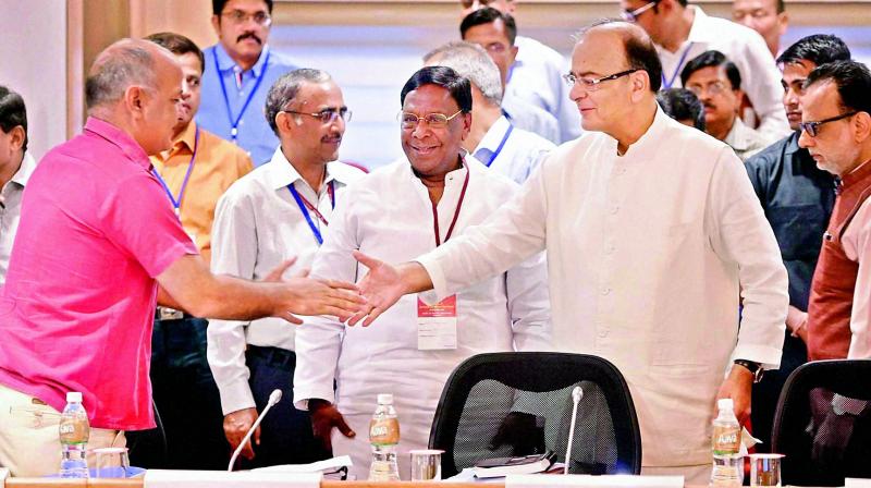 Union finance minister Arun Jaitley shakes hands with Delhi finance minister Manish Sisodia during the 3rd meeting of the GST Council in New Delhi on Tuesday.(Photo: AP)