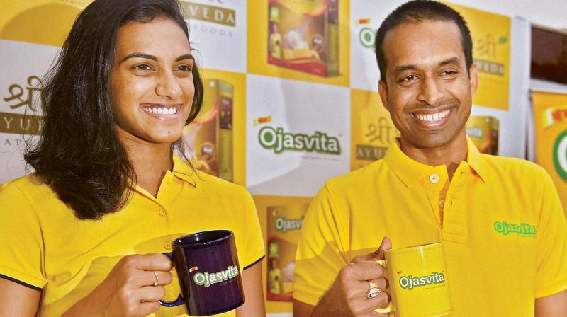 PV Sindhu with coach Pullela Gopichand during a promotional event in Mumbai on Friday.(Photo: AP)