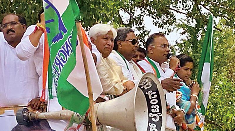 Congress leaders H.K. Patil, Siddaramaiah, Dinesh Gundurao and partys Kundgol candidate Kusuma Shivalli on their way to file papers in Kundgol on Monday