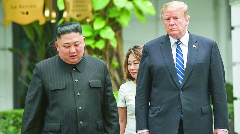 US President Donald Trump (R) walks with North Koreas leader Kim Jong Un during a break in talks at the second US-North Korea summit at the Sofitel Legend Metropole hotel in Hanoi on Thursday. (Photo: AFP)