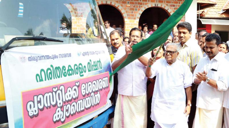 Administration Reforms Commission chairman V.S. Achuthanandan flags off a plastic collection van as part of the corporation-level Haritha Keralam programme on Thursday in Thiruvananthapuram. City Mayor V.K. Prasanth is also seen.  (Photo: DC)