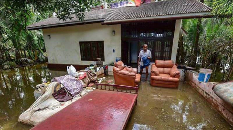 A man cleans up his house after flood water subsided, in Puthenvelikkara near Kochi. (Photo: PTI) (Photo: PTI)