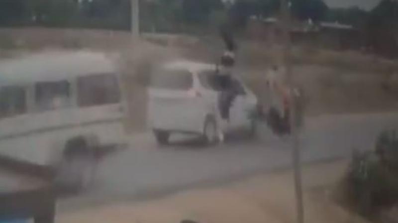 The scooter borne girls after being hit by the vehicle are seen getting flung into the air before falling on the road. (Screengrab | ANI)