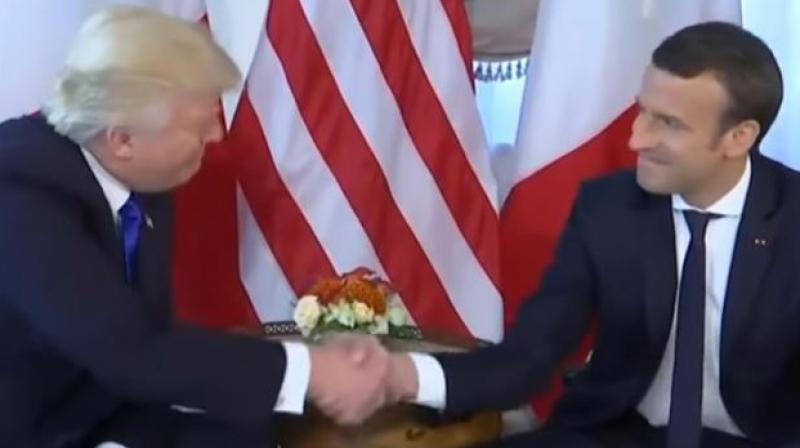 Macron held on tight to Trumps notorious power grip as the two men sat next to each other, the Frenchmans mouth clenched and eyes firmly fixed at the 70-year-old tycoons squinty stare. (P
