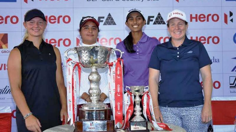 Aditi Ashok (second from right) and Amandeep Drall (second from left) pose with the Hero womens Indian Open trophy in Gurgaon on Wednesday.