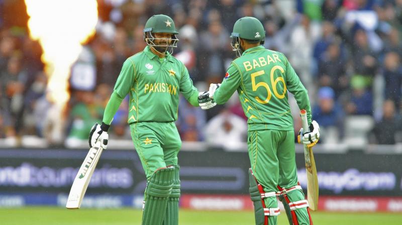Pakistans Babar Azam, right, and Pakistans Mohammad Hafeez touch gloves during the ICC Champions Trophy match between Pakistan and South Africa at Edgbaston in Birmingham, England, Wednesday, June 7, 2017 (Photo: AP)