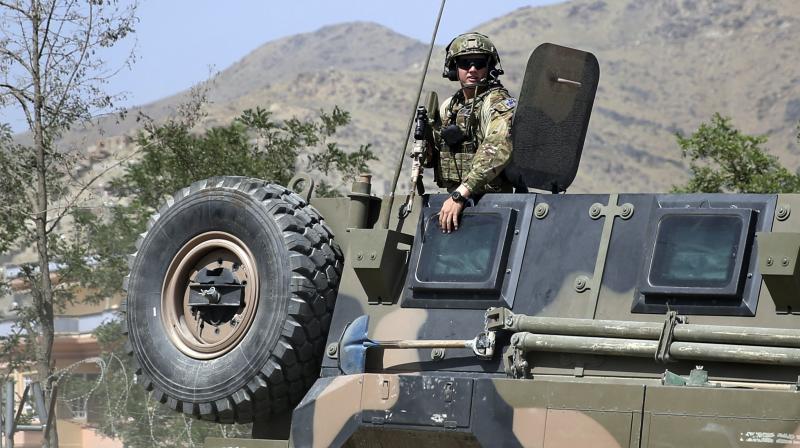 A NATO soldier keeps watch as his vehicle leaves Camp Qargha, west of Kabul, Afghanistan.(Photo: AP)
