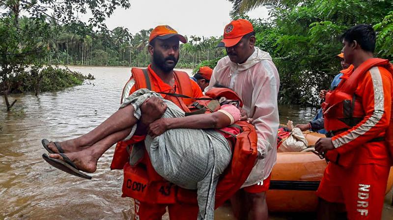 NDRF personnel rescue the flood-hit people in Wayanad, Kerala on Saturday. (Photo: PTI)