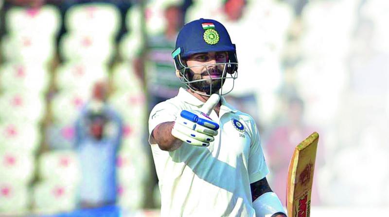 Indias captain Virat Kohli  celebrates his  century during the first day of the Test against Bangladesh in Hyderabad on Thursday.  (Photos: S. Surender Reddy)
