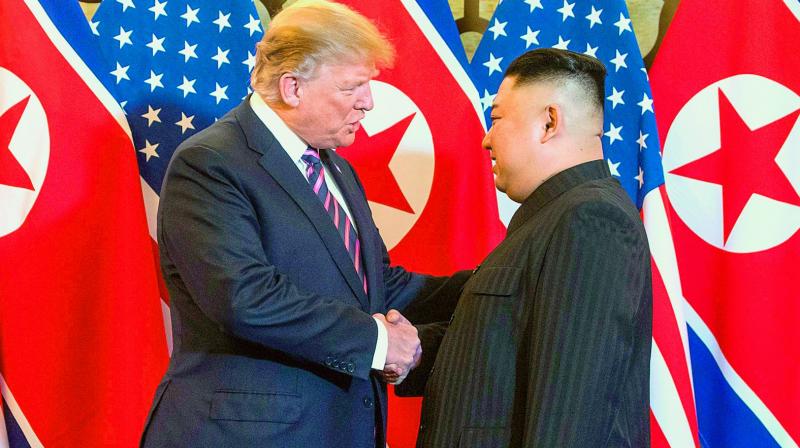 US President Donald Trump shakes hands with North Koreas leader Kim Jong Un before a meeting in Hanoi on Wednesday. (Photo: AFP)