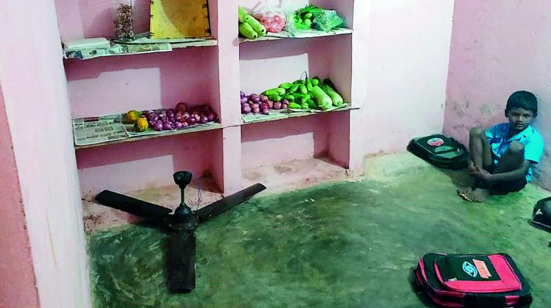 Both the kitchen and classrooms are being conducted in the same room at a seasonal hostel at Divipalem of Gudur mandal.