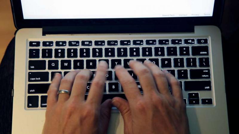 This file photo shows fingers on laptop keyboard in North Andover, Mass. (Photo: AP)